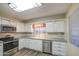 Well-lit kitchen showcasing modern appliances, white cabinetry, and sleek countertops, ready for culinary adventures at 10620 W Clair Dr, Sun City, AZ 85351