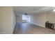 Spacious living room featuring hardwood flooring, neutral walls, and a modern ceiling fan at 10620 W Clair Dr, Sun City, AZ 85351