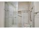 Contemporary shower with grey tile, a built-in niche, and a glass door at 10620 W Clair Dr, Sun City, AZ 85351