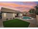 Backyard with pool, grass, lounge chairs and a covered patio, perfect for relaxation at 1070 S Amber St, Chandler, AZ 85286