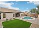 This backyard features a beautiful pool, patio, and lush green lawn, perfect for relaxing and entertaining at 1070 S Amber St, Chandler, AZ 85286