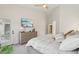 A light bedroom featuring a ceiling fan, a dresser with a TV, and a door leading outside at 1070 S Amber St, Chandler, AZ 85286