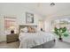 Bright bedroom featuring a decorative bed, a ceiling fan, and ample natural light from the windows at 1070 S Amber St, Chandler, AZ 85286