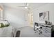 Bright bedroom featuring a ceiling fan, modern grey desk, and neutral walls at 1070 S Amber St, Chandler, AZ 85286