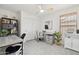 Bright bedroom featuring ceiling fan, closet and desk space; suitable for an office or bedroom at 1070 S Amber St, Chandler, AZ 85286