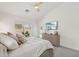 A light bedroom featuring a ceiling fan, a dresser with a TV, and a door leading outside at 1070 S Amber St, Chandler, AZ 85286