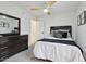 Cozy bedroom featuring neutral decor, a ceiling fan, and plenty of closet space at 1070 S Amber St, Chandler, AZ 85286