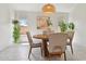 Cozy dining room with a round table, modern lighting, and bright natural light at 1070 S Amber St, Chandler, AZ 85286