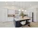 Bright modern kitchen with large island, stylish pendant lighting, stainless steel appliances, and white cabinetry at 1070 S Amber St, Chandler, AZ 85286