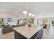 Open-concept living area featuring a spacious kitchen island, cozy living room, and bright natural lighting at 1070 S Amber St, Chandler, AZ 85286