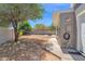 View of the property backyard with desert landscaping, patio, and a privacy wall at 1130 S Surfside Dr, Gilbert, AZ 85233