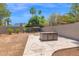 Backyard features a patio area with an outdoor dining set, trees, and a privacy wall at 1130 S Surfside Dr, Gilbert, AZ 85233