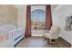 Cozy Bedroom with a crib, rocking chair, and a large window providing natural light at 1130 S Surfside Dr, Gilbert, AZ 85233