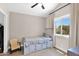 Bright bedroom featuring a bed with storage drawers, a window, and a ceiling fan at 1130 S Surfside Dr, Gilbert, AZ 85233