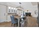 Cozy dining room with a fireplace, modern lighting fixture, and stylish furniture at 1130 S Surfside Dr, Gilbert, AZ 85233