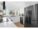 Bright kitchen with white cabinetry, stainless steel appliances, and a window view at 1130 S Surfside Dr, Gilbert, AZ 85233