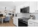 Modern kitchen with stainless steel appliances and herringbone backsplash open to dining area at 1130 S Surfside Dr, Gilbert, AZ 85233