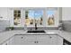 Bright kitchen sink with quartz countertops and a sunny neighborhood view at 1130 S Surfside Dr, Gilbert, AZ 85233