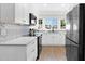 Modern kitchen with white cabinets, sleek countertops, stainless steel appliances, and natural lighting at 1130 S Surfside Dr, Gilbert, AZ 85233