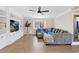 Comfortable living room with a large sectional sofa, ceiling fan and built in entertainment center at 1130 S Surfside Dr, Gilbert, AZ 85233