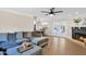Open-concept living room with comfortable seating, fireplace, and view of kitchen and dining at 1130 S Surfside Dr, Gilbert, AZ 85233