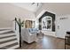 Bright and airy living room features a high vaulted ceiling, modern furniture, and a staircase to the second floor at 1130 S Surfside Dr, Gilbert, AZ 85233