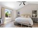 Inviting primary bedroom with vaulted ceilings, windows, and a bench seat at the foot of the bed at 1130 S Surfside Dr, Gilbert, AZ 85233