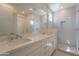 Modern bathroom features dual sinks, quartz countertops, and a glass-enclosed shower at 11300 N Casa Dega Dr # 1090, Surprise, AZ 85388