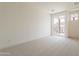 Bright bedroom with neutral carpet and sliding glass doors to a balcony at 11300 N Casa Dega Dr # 1090, Surprise, AZ 85388