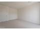 Clean bedroom features neutral carpet and a door to the walk-in closet at 11300 N Casa Dega Dr # 1090, Surprise, AZ 85388