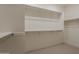 Large walk-in closet featuring metal racks and neutral carpeting at 11300 N Casa Dega Dr # 1090, Surprise, AZ 85388