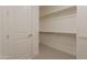 Bright walk-in closet with metal racks and neutral carpeting at 11300 N Casa Dega Dr # 1090, Surprise, AZ 85388