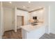 Modern kitchen featuring white cabinetry, stainless steel appliances, and quartz countertops with wood-style flooring at 11300 N Casa Dega Dr # 1090, Surprise, AZ 85388