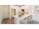 Open kitchen with white cabinets, a large island, and modern countertops with bar stool seating at 11300 N Casa Dega Dr # 1090, Surprise, AZ 85388