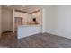 Bright kitchen featuring white cabinetry, stainless steel appliances, and quartz countertops with wood-style flooring at 11300 N Casa Dega Dr # 1090, Surprise, AZ 85388