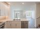 Bright, open-concept kitchen with white cabinetry, quartz countertops, and stainless steel appliances at 11300 N Casa Dega Dr # 1090, Surprise, AZ 85388