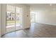 Bright living room with sliding glass door, recessed lighting, and wood-style flooring at 11300 N Casa Dega Dr # 1090, Surprise, AZ 85388