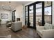 A cozy living room with fireplace, modern furniture, and glass doors leading to an outdoor patio, creating a seamless indoor-outdoor flow at 11300 N Casa Dega Dr # 1090, Surprise, AZ 85388
