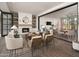 Open-concept living room with a fireplace, inviting seating, and seamless flow to other spaces at 11300 N Casa Dega Dr # 1090, Surprise, AZ 85388