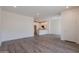 Open-plan living room with a view into the kitchen area and wood-style flooring, bathed in natural light at 11300 N Casa Dega Dr # 1090, Surprise, AZ 85388