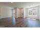 Bright, open-plan living room with wood floors, a large window and sliding glass doors at 11300 N Casa Dega Dr # 1090, Surprise, AZ 85388