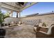 Inviting outdoor patio featuring a cozy fire pit and water feature, perfect for entertaining and relaxation at 11300 N Casa Dega Dr # 1090, Surprise, AZ 85388