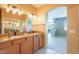 Bathroom displaying double sinks with granite countertops, decorative lighting and tiled flooring at 11500 E Cochise Dr # 2088, Scottsdale, AZ 85259