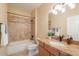 Bathroom featuring granite countertop sink, tiled shower-tub combination and decorative mirror at 11500 E Cochise Dr # 2088, Scottsdale, AZ 85259
