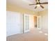 Bedroom with ceiling fan, light walls and french doors leading to the adjacent room at 11500 E Cochise Dr # 2088, Scottsdale, AZ 85259
