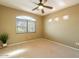 Neutral bedroom with tan walls, ceiling fan and large window letting in natural light at 11500 E Cochise Dr # 2088, Scottsdale, AZ 85259