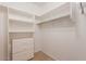 Walk-in closet with white shelving, built-in drawers and rod for hanging clothes at 11500 E Cochise Dr # 2088, Scottsdale, AZ 85259