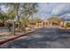 Community entrance with mature trees, native vegetation, and secure gated access at 11500 E Cochise Dr # 2088, Scottsdale, AZ 85259