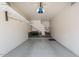 Spacious garage with epoxy flooring, overhead storage racks, and access to upper floor at 11500 E Cochise Dr # 2088, Scottsdale, AZ 85259