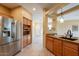 Kitchen view with stainless steel refrigerator and sink with breakfast bar access to dining space at 11500 E Cochise Dr # 2088, Scottsdale, AZ 85259